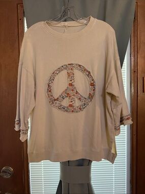 Cream color top by easel size small. Oversize fit